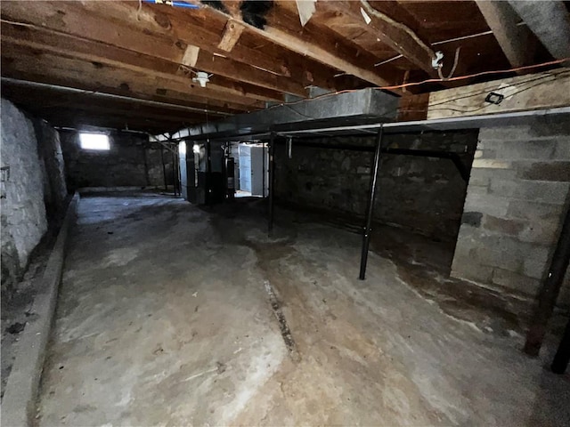 unfinished basement featuring heating unit