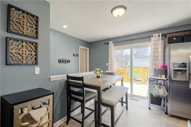 dining room with a textured ceiling