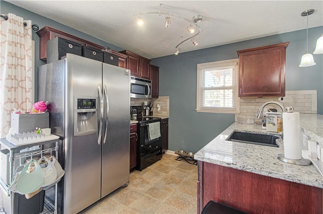 kitchen with stainless steel appliances, a sink, decorative backsplash, light stone countertops, and pendant lighting