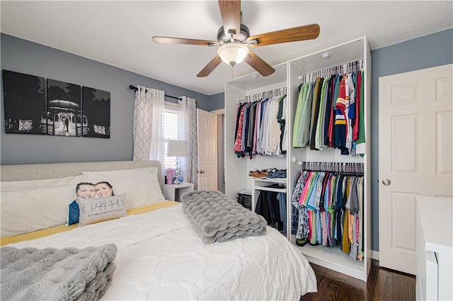 bedroom featuring a ceiling fan, a closet, and wood finished floors