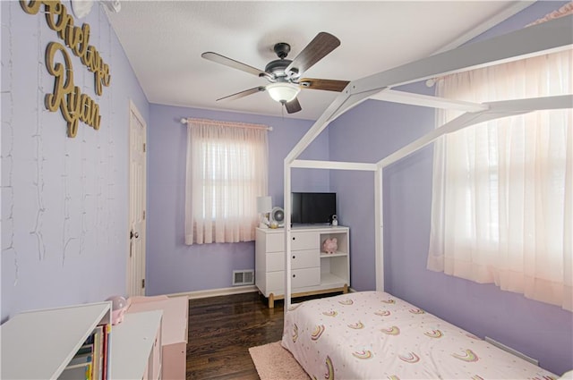 bedroom with ceiling fan, dark wood finished floors, and visible vents