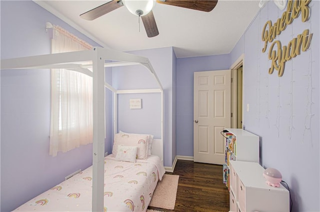 bedroom with dark wood-style floors and a ceiling fan