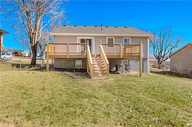 back of property with stairway, a yard, fence, a wooden deck, and central AC