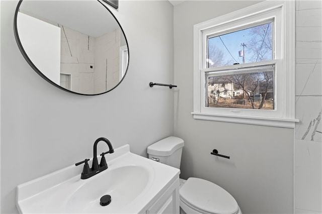 bathroom featuring toilet and vanity