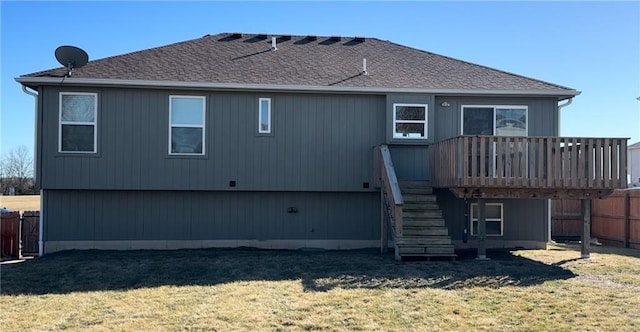 rear view of property featuring stairs, a yard, a deck, and fence