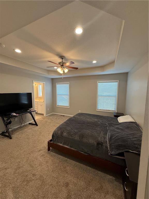 bedroom featuring baseboards, carpet floors, a raised ceiling, and recessed lighting