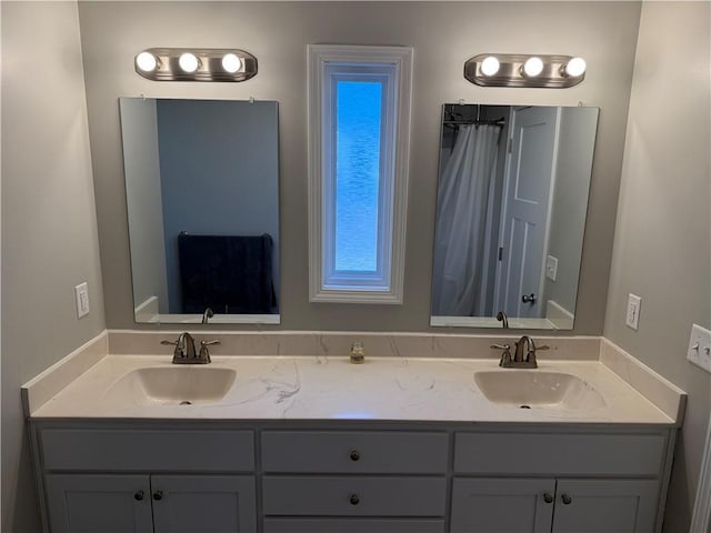 bathroom featuring double vanity and a sink