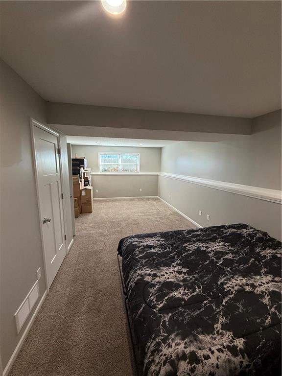 bedroom with carpet flooring and baseboards