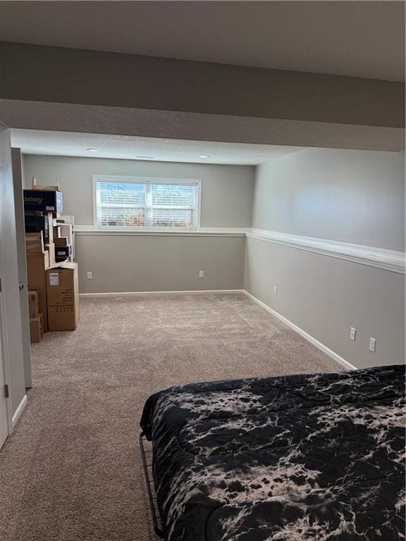 bedroom featuring carpet floors and baseboards