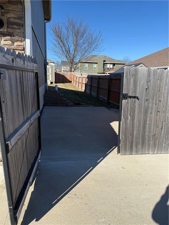 exterior space featuring a patio area, fence private yard, and a gate