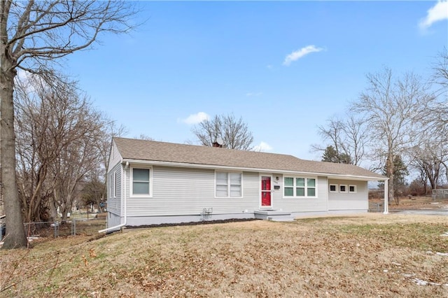 single story home with driveway, a front lawn, entry steps, fence, and an attached garage