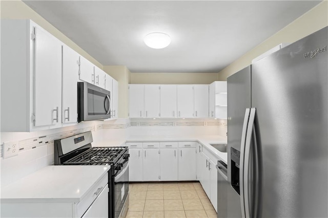 kitchen featuring tasteful backsplash, light countertops, light tile patterned flooring, stainless steel appliances, and open shelves