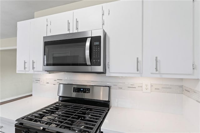 details with light countertops, white cabinets, backsplash, and appliances with stainless steel finishes