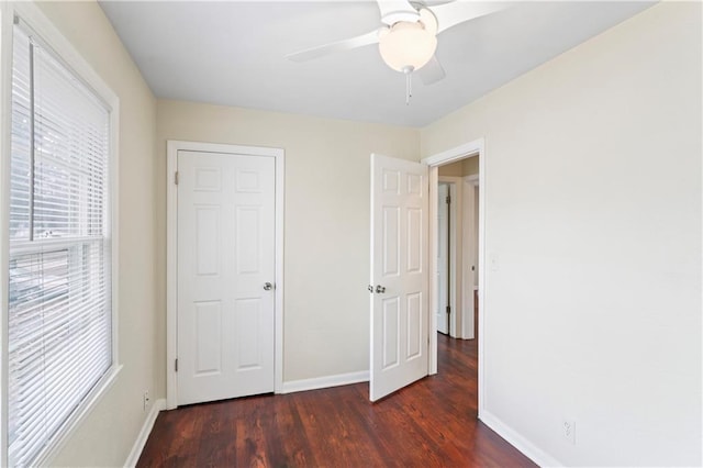 unfurnished bedroom featuring a ceiling fan, wood finished floors, and baseboards