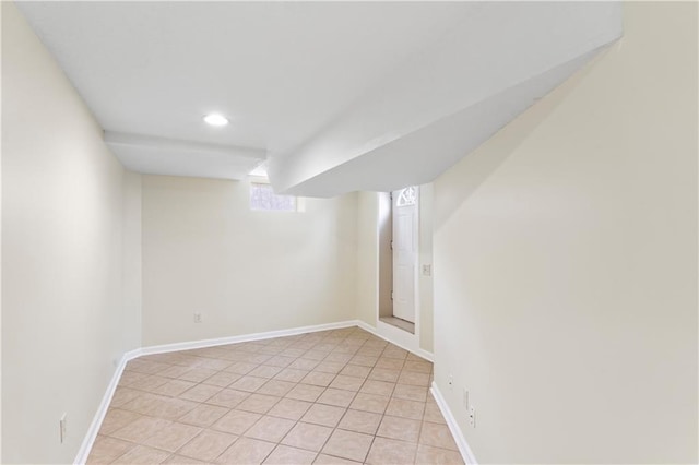 below grade area featuring light tile patterned floors, recessed lighting, and baseboards