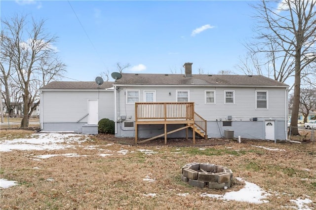 rear view of house with a wooden deck, central air condition unit, a fire pit, and stairway