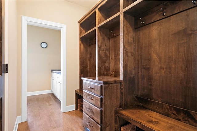 mudroom with baseboards and wood finished floors