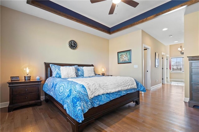 bedroom featuring wood finished floors, beam ceiling, and baseboards