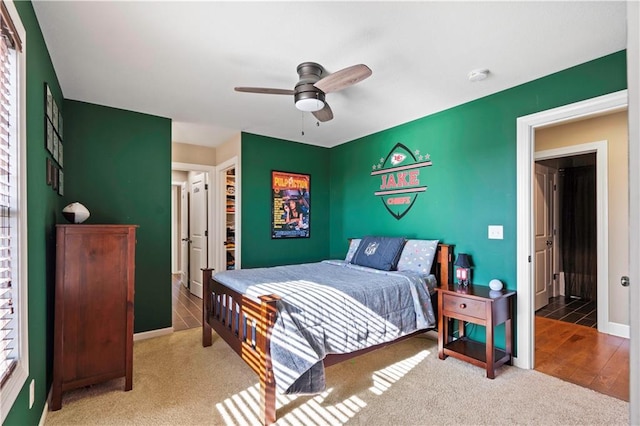 carpeted bedroom featuring ceiling fan and baseboards