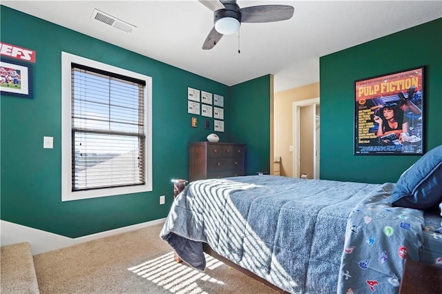 carpeted bedroom with baseboards, visible vents, and ceiling fan