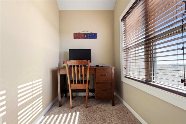 carpeted home office featuring baseboards