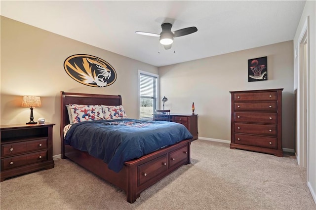 bedroom with light carpet, a ceiling fan, and baseboards