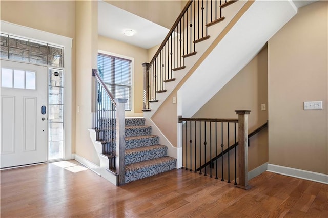 entryway with baseboards and wood finished floors