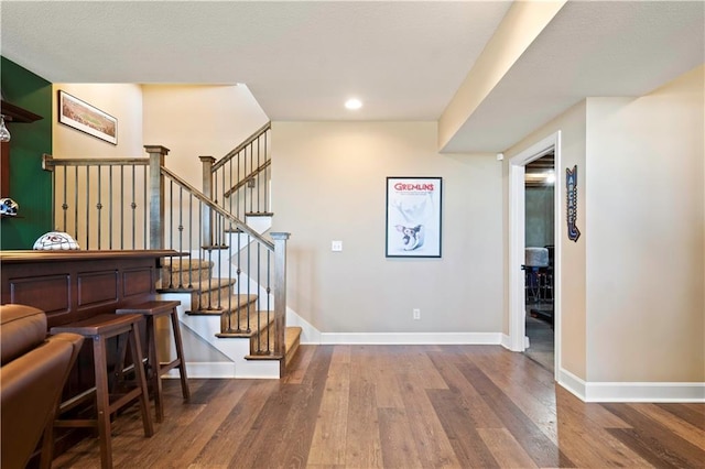 entryway with recessed lighting, baseboards, and wood finished floors