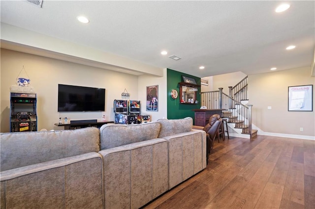 living area featuring recessed lighting, wood-type flooring, stairway, and baseboards