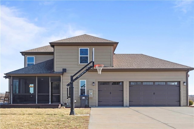 traditional-style house with a garage, a sunroom, driveway, roof with shingles, and a front lawn