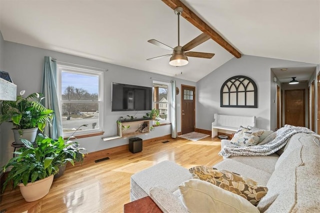 living room with vaulted ceiling with beams, visible vents, plenty of natural light, and wood finished floors