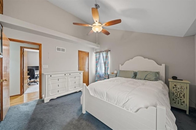 bedroom featuring dark colored carpet, visible vents, vaulted ceiling, and ceiling fan