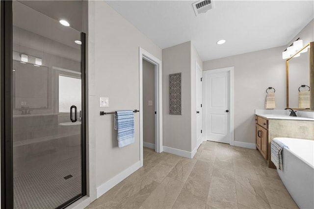 16967 S Hunter St, Olathe, KS 66062 - full bath with a soaking tub, visible vents, a shower stall, vanity, and baseboards