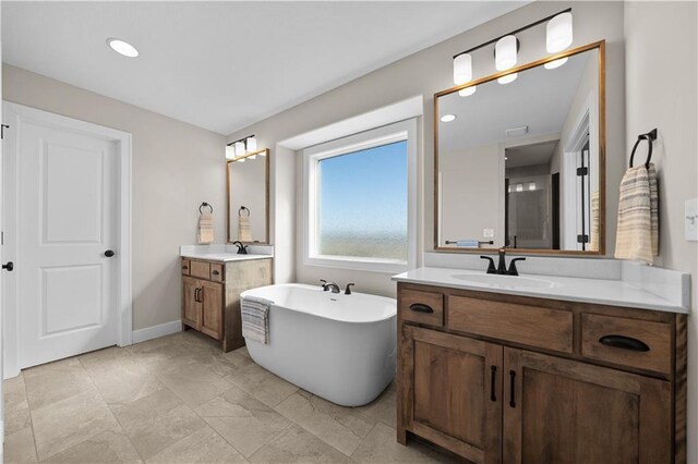 16967 S Hunter St, Olathe, KS 66062 - full bath with two vanities, a soaking tub, a sink, and baseboards
