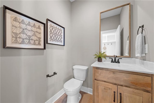 16967 S Hunter St, Olathe, KS 66062 - bathroom featuring baseboards, vanity, toilet, and wood finished floors