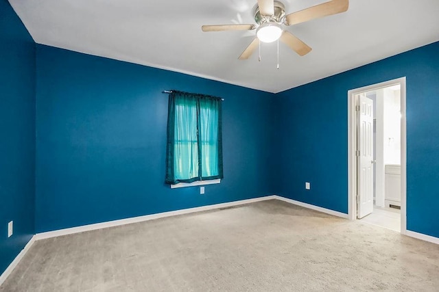 empty room with a ceiling fan and baseboards