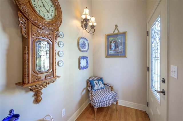 living area featuring baseboards and wood finished floors