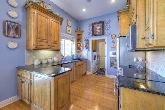 kitchen with appliances with stainless steel finishes, brown cabinets, separate washer and dryer, a peninsula, and open shelves