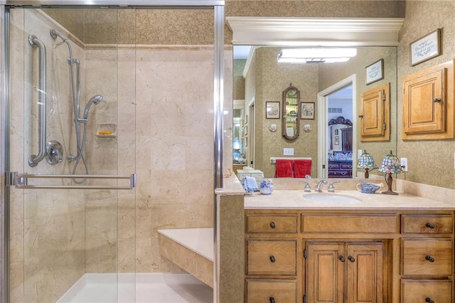 bathroom with a shower stall and vanity