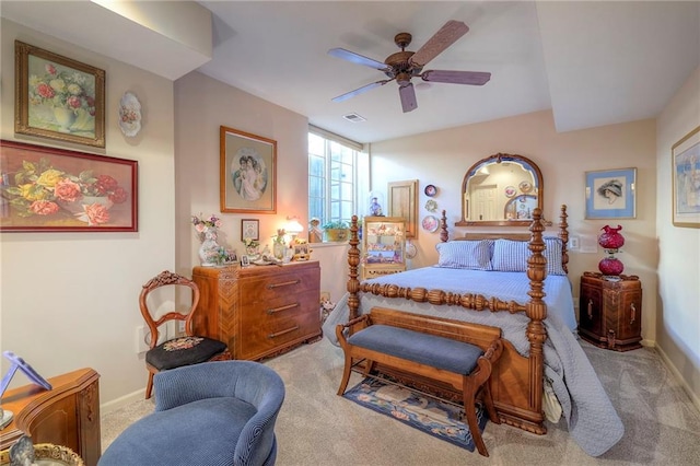 carpeted bedroom with a ceiling fan, visible vents, and baseboards