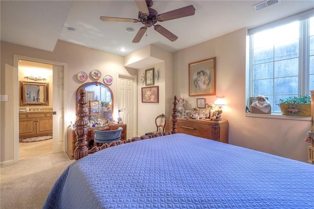 bedroom featuring ceiling fan, carpet, visible vents, and ensuite bathroom