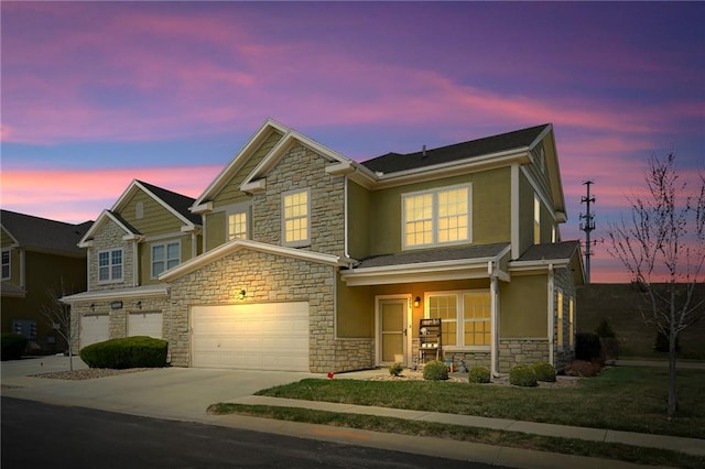 16059 Fontana St Unit 205, Overland Park, KS 66085 - view of front of home with covered porch, a garage, concrete driveway, stone siding, and stucco siding