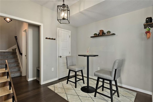 16059 Fontana St Unit 205, Overland Park, KS 66085 - living area with stairway, baseboards, an inviting chandelier, and wood finished floors