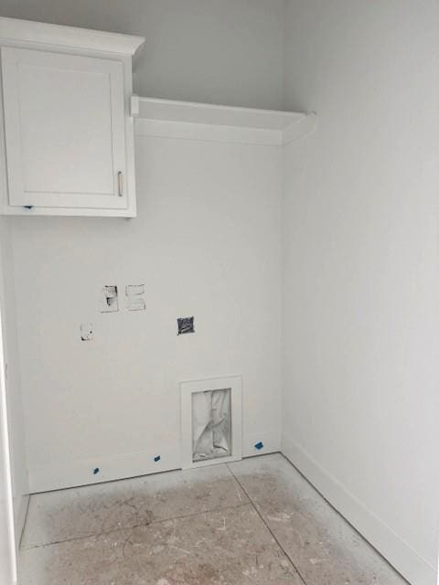 laundry area with cabinet space and baseboards