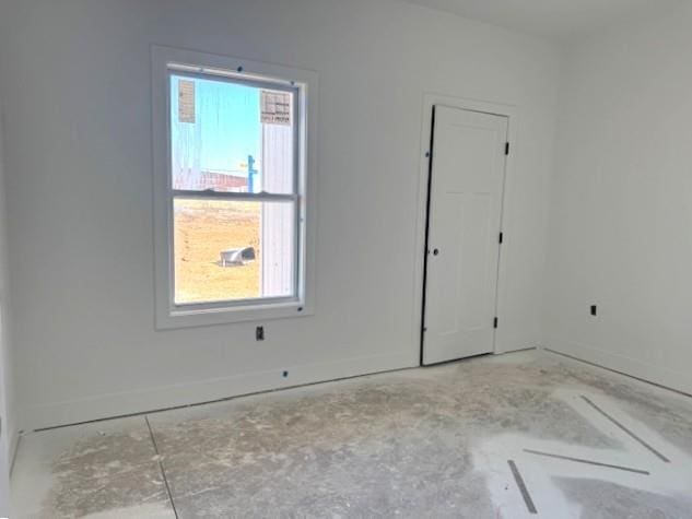 unfurnished room featuring baseboards