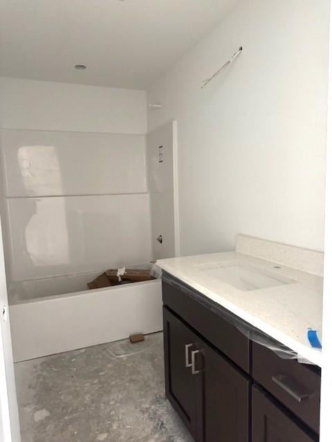 full bath with unfinished concrete floors, vanity, and shower / bathtub combination