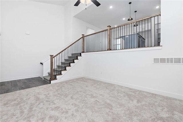 stairs featuring recessed lighting, a high ceiling, carpet flooring, visible vents, and baseboards