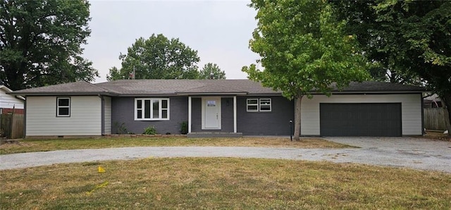 ranch-style home with a garage, driveway, crawl space, and a front yard