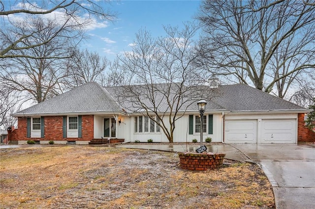 ranch-style home with a garage, concrete driveway, roof with shingles, and brick siding