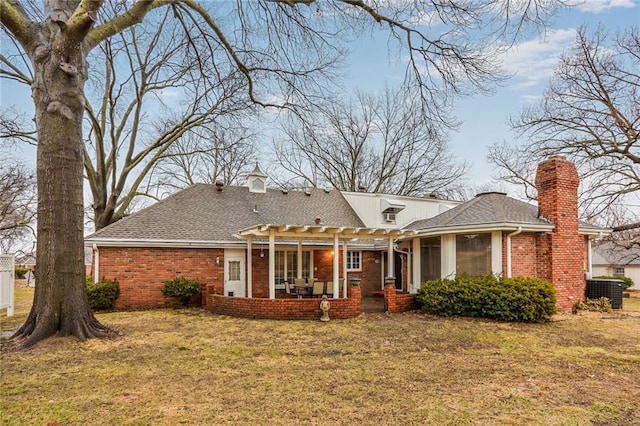 exterior space with roof with shingles, a pergola, a lawn, and brick siding